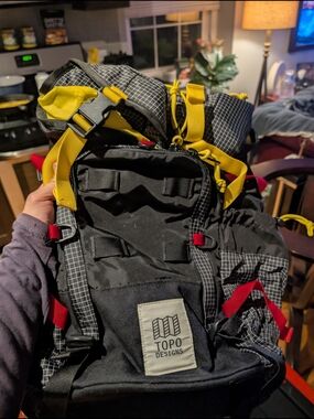 Topo Designs Black Backpack with Yellow and Red Accents
